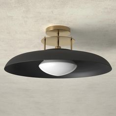 a black and gold ceiling light in a room