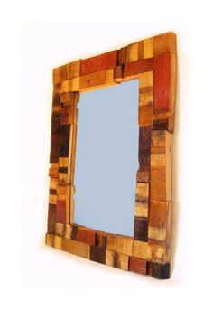 a mirror made out of wooden blocks on a wall