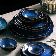 a table topped with lots of blue dishes