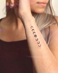 a woman with a tattoo on her arm that reads,'i love you to the moon