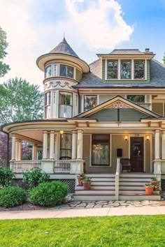 a large victorian style house with lots of windows and balconies on the front porch