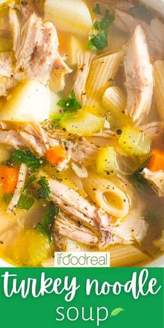 a bowl of turkey noodle soup with carrots and parsley