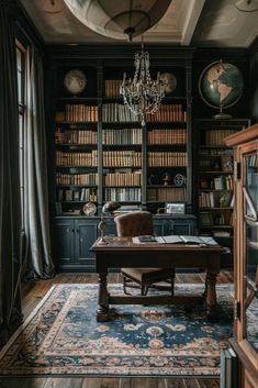 an old fashioned desk in front of a bookcase with many books on it and a chandelier hanging from the ceiling