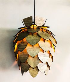 a wooden chandelier hanging from the ceiling with lights on it's sides