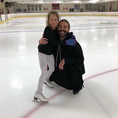 a man and girl hugging on an ice rink