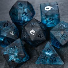 blue and black dice with white ink on them