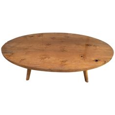 an oval wooden table with two legs and a wood top, on a white background