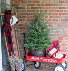 a christmas tree sitting on top of a red wagon