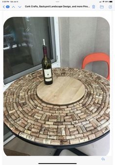 a wine bottle sitting on top of a wooden table