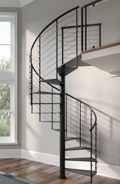 a spiral staircase in an empty room next to a window