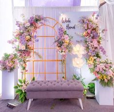 a bench with flowers on it in front of a backdrop