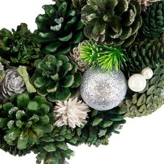 Artificial pinecone and foliage Christmas wreath. Green pinecones; burrs and foliage fill the wreath. Shiny silver ornaments and small white berries complete the wreath Unique Wreath, White Berries, Artificial Christmas Wreaths, Christmas Central, Hanging Wreath, Glitter Ornaments, Silver Ornaments, Green Foliage, Holiday Wreaths