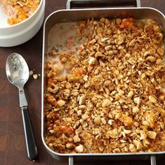 a casserole dish with nuts and other toppings next to a bowl of cereal