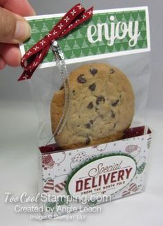 a hand holding a cookie in a package