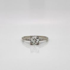 a white gold ring with an oval cut diamond