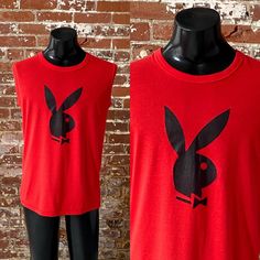 *1980s Cherry Red Playboy Bunny Box Tee *Vintage 80s Playboy Bunny Logo Graphic Sleeveless T-Shirt Notes: *Good vintage condition; faint black line upper chest/shoulder area above graphic - pictured; material pilled here and there *Single stitch Sundancer tee; 50% Cotton 50% Polyester; made in Canada; tag size XL *Fits like men's size Large Measurements: Pit to pit: 21.25"  Length, shoulder to bottom: 28.5"  *Item is vintage and sold as is *Feel free to message me for any additional details  *Pl Vintage Tank Top For Spring Streetwear, Vintage Crew Neck Muscle Tee For Summer, Vintage Crew Neck Tank Top For Summer, Vintage Cotton Muscle Tee For Spring, Red Sleeveless T-shirt For Spring, Red Vintage Vest For Summer, Vintage Red Vest For Summer, Retro Sleeveless Summer T-shirt, Vintage Tank Top For Streetwear