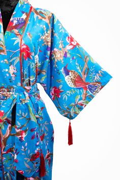 A stunning Birds of Paradise print kimono. With a number of colours to choose from, you will be spoilt for choice The fabric is easy to clean and easy to wear. The soft cotton, gentle material and luxurious drape, whether you're lounging or layering, this kimono cover up will make you feel like a queen. It also has 4 beautiful handmade tassels, 2 on the sleeves and 2 on the belt, making this a Limited Edition. With a loose swing shape for an easy, flowy fit makes this robe extremely comfortable and elegant to wear. The print covers the entire front and back panel and is piped in a lovely contrast colour. Use the belt included with the dress if you prefer a more fitted look. Our kimono comes in 4 sizes and 3 lengths, Size: *SMALL will fit size UK 8-12 /US 4-8 . Width is 120cm. Will fit up t Patterned Wrap Kimono With Print, Blue Summer Kimono For Home, Patterned Printed Wrap Kimono, Patterned Cotton Kimono With Kimono Sleeves, Summer Blue Kimono For Home, Blue Floral Print Wrap Kimono, Blue Floral Print Beach Robe, Blue Floral Print Robe For Home, Blue Kimono Sleeve Robe For Home