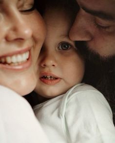 a close up of a person holding a baby