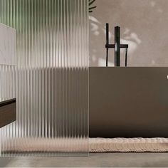 a bathroom with a sink, mirror and bathtub next to a potted plant