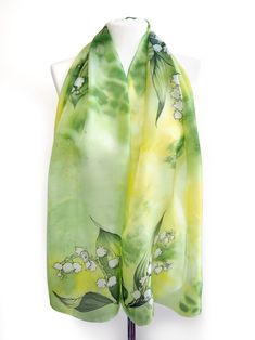 Lily of the Valley silk scarf was hand painted on lightweight Habotai. Size is 61 inches in lenght and 17 inches in width. (155 by 43 centimeters) Silk is called Habotai Light, a Chinese pure silk of delicate gloss, delicacy and charm. This foulard is painted with silk paints in bright yellowish green color set with a detailed and realistic picture of Lily of the valley flowers on both ends and in the middle. Please allow for small differences in color set and design due to the nature of hand ma Green Scarf As Spring Gift, Green Scarves For Spring Gift, Green Scarf For Spring Gift, Hand Painted Green Silk Scarf, Green Floral Print Scarf For Gift, Green Floral Print Scarves As Gift, Artistic Green Silk Scarf With Floral Print, Artistic Hand Painted Green Silk Scarf, Lily Valley