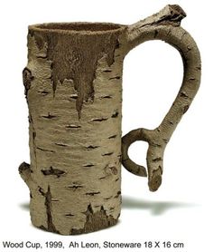 a ceramic mug made to look like a tree trunk