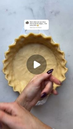 a person holding a pie crust in front of a video screen with the recipe on it