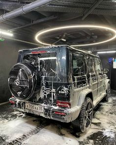 a black and white jeep with skulls painted on it's hood in a parking garage