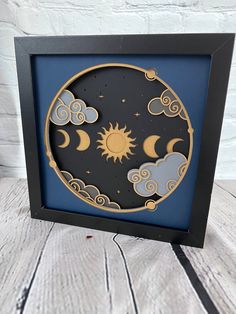 a shadow box with the sun and moon in it