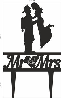 a couple kissing on top of a sign with the word mr and mrs in black