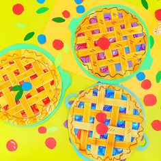 three pies cut out of paper on a yellow tablecloth with polka dotes