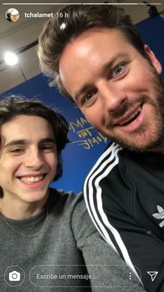 two young men are posing for a photo