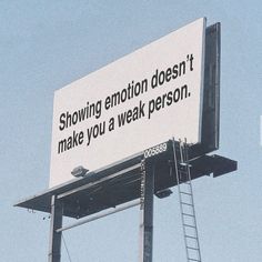 a billboard with a ladder on it that says, showing emotion doesn't make you a weak person