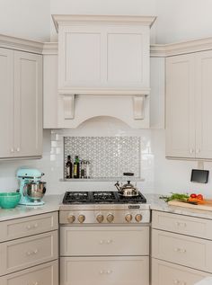 a kitchen with white cabinets and an oven