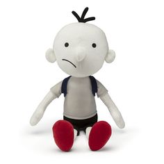 a white stuffed toy with black hair and red feet