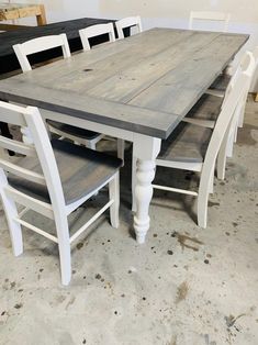 a table and chairs in a room with unfinished walls