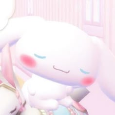 a white bunny sitting on top of a bed next to a stuffed animal rabbit in a pink room