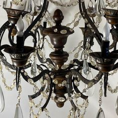 an antique chandelier with crystal drops hanging from it