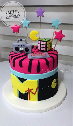 a colorful cake decorated with stars and music equipment