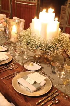 the table is set with candles and place settings for dinner guests to sit down at