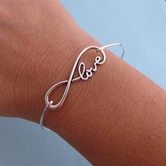 "An elegant love, infinity charm in silver tone will be fashioned into a bangle bracelet with band choice of silver filled or sterling silver. This infinity bracelet bangle makes for wonderful gift for wife or girlfriend. Please specify size in notes to seller during checkout for your infinity bracelet... Choose from one of my regular sizes below or by measuring one of your favorite bangles, or give me the circumference of the widest part of your hand where the bangle has to be pulled over; then Silver Infinity Bracelet For Anniversary, Sterling Silver Infinity Bracelet For Valentine's Day, Sterling Silver Infinity Bracelets For Anniversary, Sterling Silver Infinity Bracelet For Anniversary, Sterling Silver Bangle For Birthday, Valentine's Day Sterling Silver Infinity Bracelet, Valentine's Day Infinity Sterling Silver Bracelet, Silver Infinity Bracelet For Mother's Day, Silver Infinity Bracelet For Gift