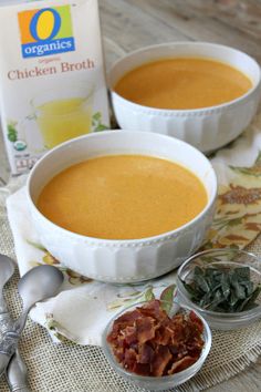 two bowls filled with soup next to a carton of milk