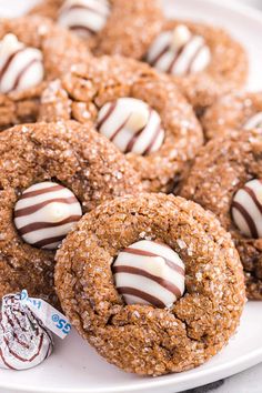 chocolate covered cookies on a white plate with candy