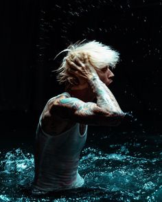 a woman with tattoos standing in the water