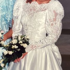 two women in wedding dresses standing next to each other