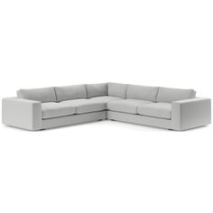 a white sectional couch sitting on top of a white floor