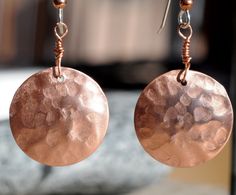 the earrings are made with copper colored metal