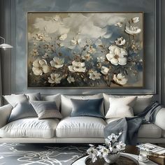 a living room filled with furniture and a large painting on the wall above it's couch