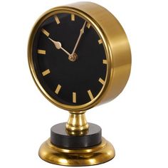 a black and gold clock is on a small stand with a white back ground behind it