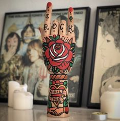 a woman's hand with tattoos and roses on it