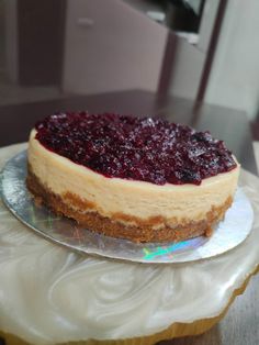 a cheesecake with berry topping on a plate